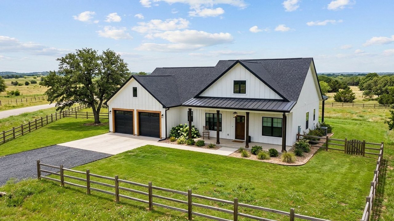 Farmhouse manufactured home with attached two-car garage and large green yard