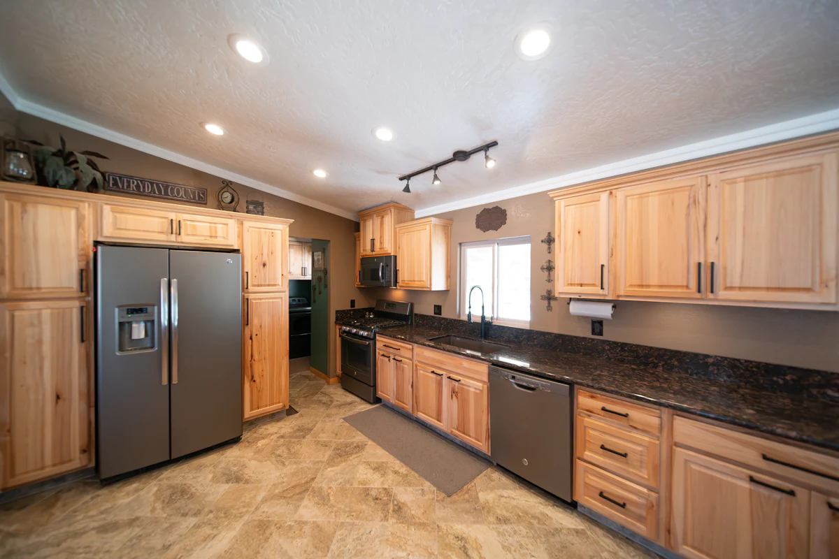 Kitchen with wood cabinets inside a double wide mobile home