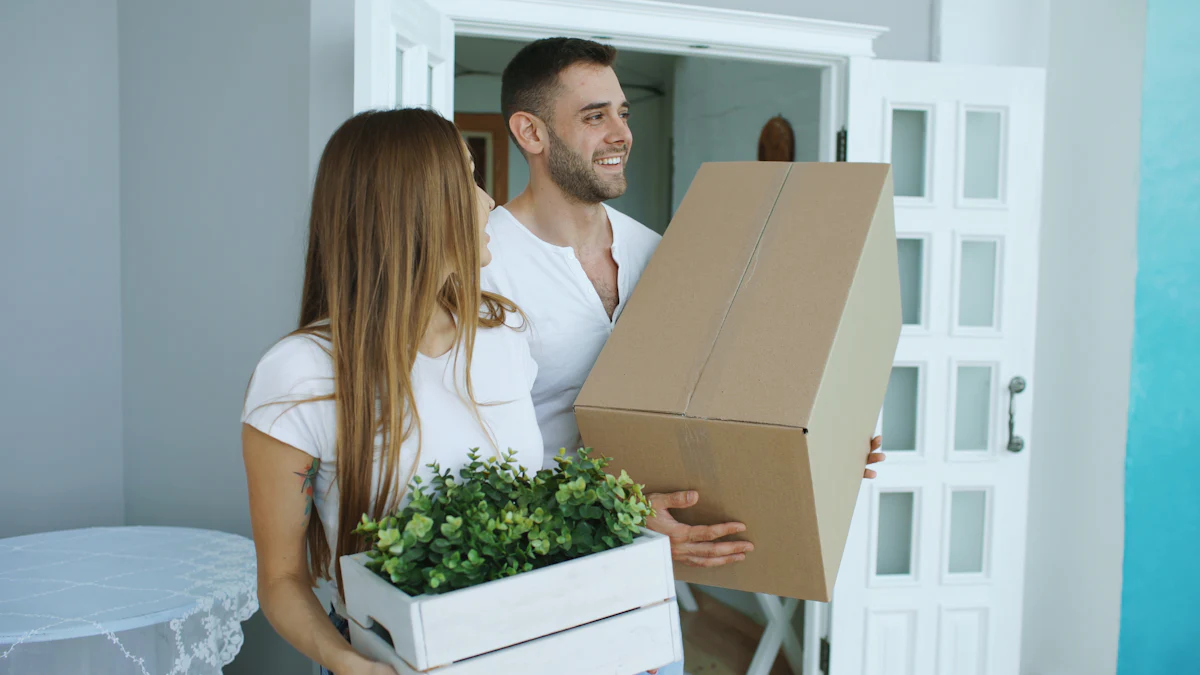 Couple carrying moving boxes into their new mobile home