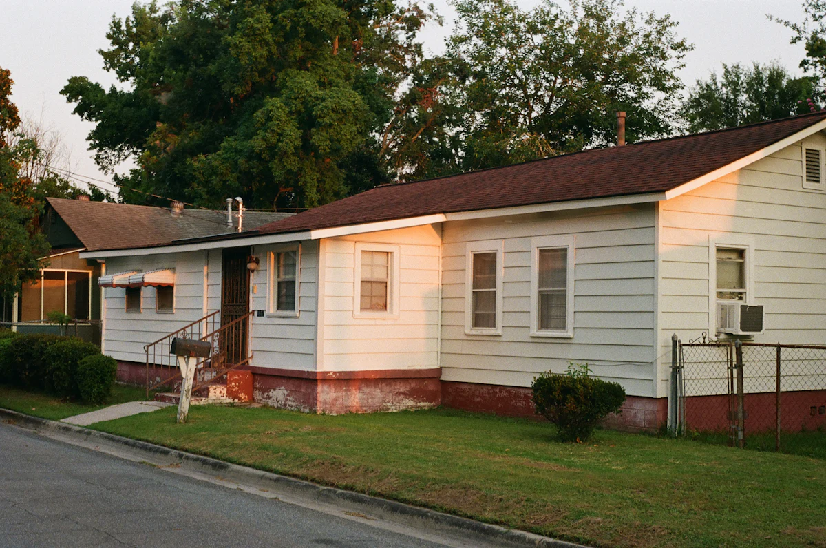 Used white mobile home with brown trim near trees